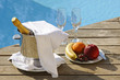 Photo: Champagne at poolside with plate of fruits and glasses Champagne at poolside with plate of fruits and glasses