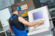 worker operating cnc punch press