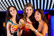 People with cocktails in bar or club