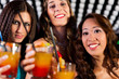 People with cocktails in bar or club