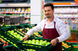 Man in supermarket as shop assistant