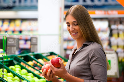 Photo: Woman in supermarket shopping groceries Woman in supermarket shopping groceries