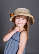 Little girl in a dress with a straw hat Little girl in a dress with a straw hat