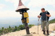 Two male friends looking at the direction sign in the mountains