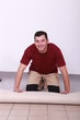 Artisan laying carpet