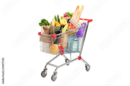 Photo: A shopping cart full with various groceries A shopping cart full with various groceries