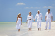 Two Couples Generations of Family Walking on Tropical Beach