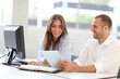 Young adults in training course using touchpad