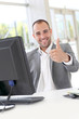 Happy businessman showing thumbs up