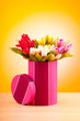 Giftbox and tulips against gradient background