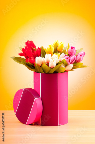 Photo: Giftbox and tulips against gradient background Giftbox and tulips against gradient background