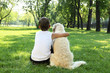 Foto: Tennager boy in the park with a dog Tennager boy in the park with a dog