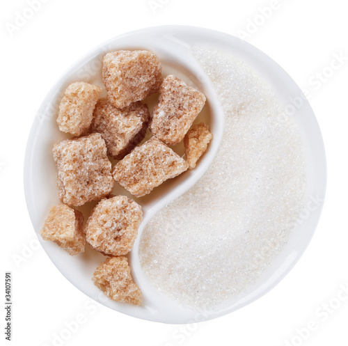 Photo: Brown lump cane sugar versus white one in Yang Yin shaped plate, Brown lump cane sugar versus white one in Yang Yin shaped plate,