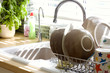 Kitchen sink and washing up in summer sunlight