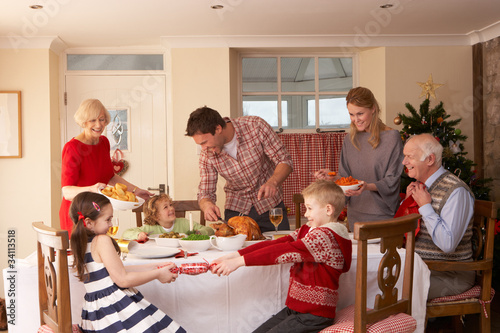Photo: Family serving Christmas dinner Family serving Christmas dinner