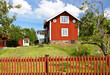 Red fence and a red cottage.