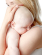 baby asleep on mother's shoulder baby asleep on mother's shoulder