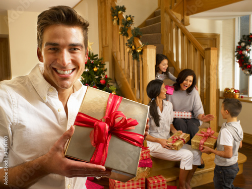 Photo: Hispanic family exchanging gifts at Christmas Hispanic family exchanging gifts at Christmas