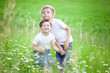 Siblings playing in field
