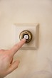 Close-up of a person's hand ringing door bell