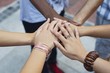 Close-up of human hands stacked upon one another