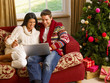 Photo: Young Hispanic couple Christmas shopping online Young Hispanic couple Christmas shopping online
