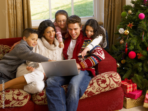 Photo: Hispanic family Christmas shopping online Hispanic family Christmas shopping online