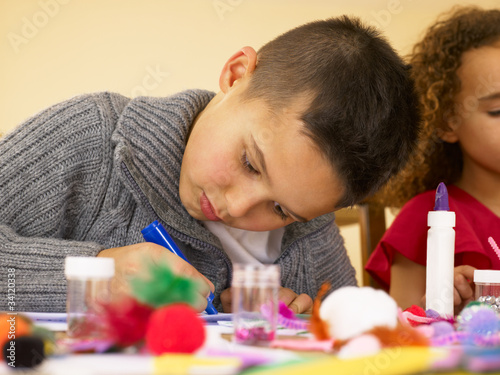 Photo: Young mixed race children doing handicrafts Young mixed race children doing handicrafts
