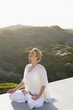 Mid adult woman meditating