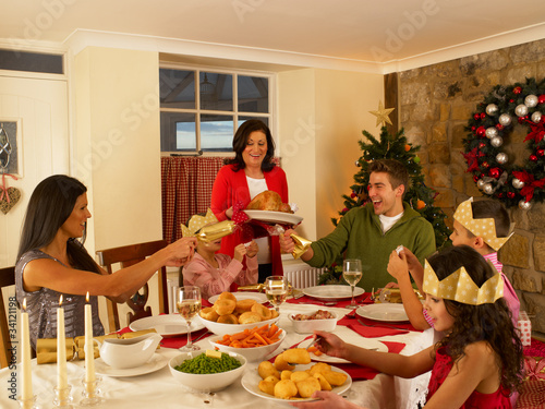 Photo: Hispanic family having Christmas dinner Hispanic family having Christmas dinner