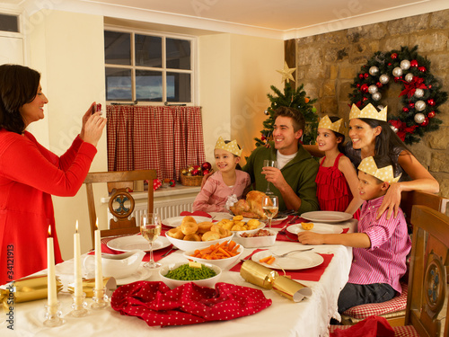 Photo: Hispanic family taking photos of Christmas dinner Hispanic family taking photos of Christmas dinner