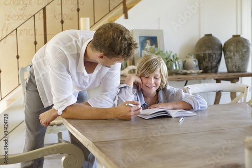 Photo: Man teaching his son at house Man teaching his son at house