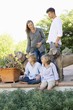 Family having a good time outside house with two dogs