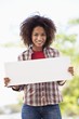 Portrait of a woman holding a blank placard