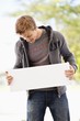 Man looking at a blank placard