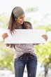 Smiling woman looking at a blank placard