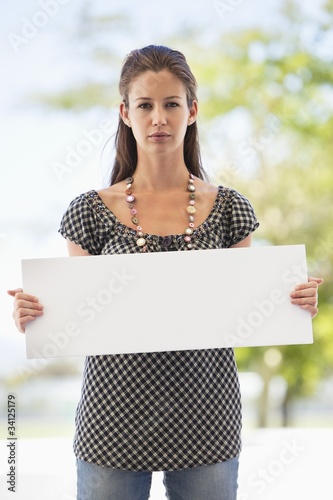 Photo: Portrait of a woman holding a blank placard Portrait of a woman holding a blank placard