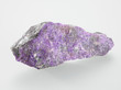 Foto: Mineral Sugilit on grey background Mineral Sugilit on grey background