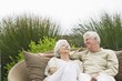 Senior couple sitting in a wicker couch