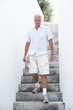 Senior man getting down steps