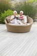 Senior couple sitting in a wicker couch reading a magazine