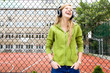 Teenage girl standing in front of fence