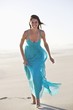 Smiling woman running on the beach
