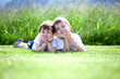 siblings lying on grass