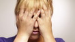 Frustrated woman holding hands on face