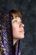 Photo: beautiful woman with shawl on head looking up as if praying beautiful woman with shawl on head looking up as if praying