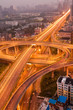 Freeway in night with cars light in modern city.