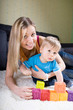 Photo: Young mother playing with baby boy Young mother playing with baby boy