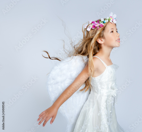Photo: Angel children girl wind in hair fashion flowers crown Angel children girl wind in hair fashion flowers crown