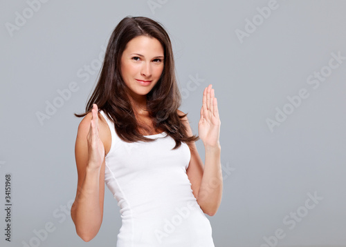 Photo: Young woman shows medium size with hands Young woman shows medium size with hands
